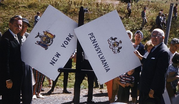 Representatives from both Pennsylvania and New York standing at the state line