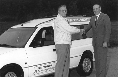 Representative Herman Mihalich and West Penn Power President Jay Pifer with the Ford Ecostar van in the background