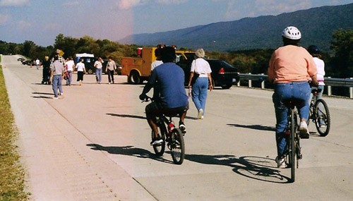 "Roll & Stroll" attendees walking and biking down the unopened expressway