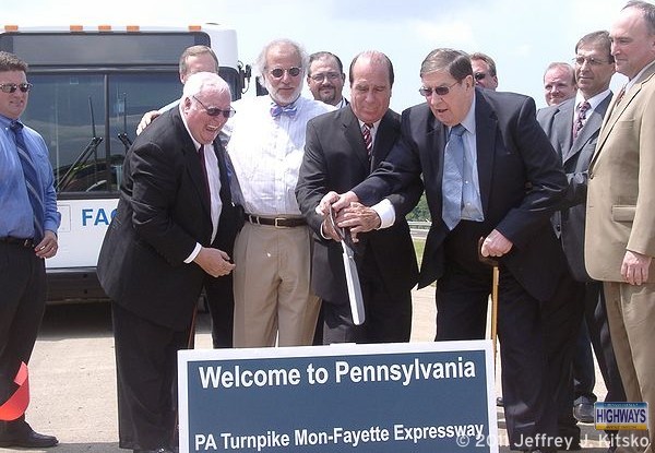 Local and state officials cutting the ribbon for PA Turnpike 43 at the state line