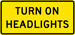 Turn On Headlights sign